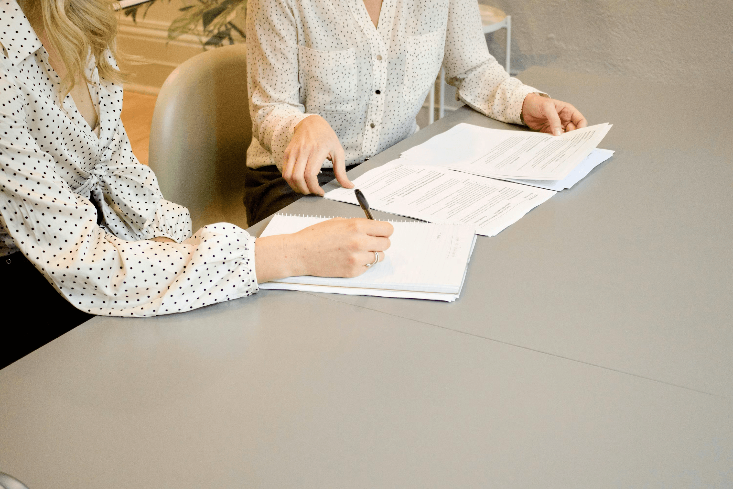 Office workers filling insurance paperwork in a modern office