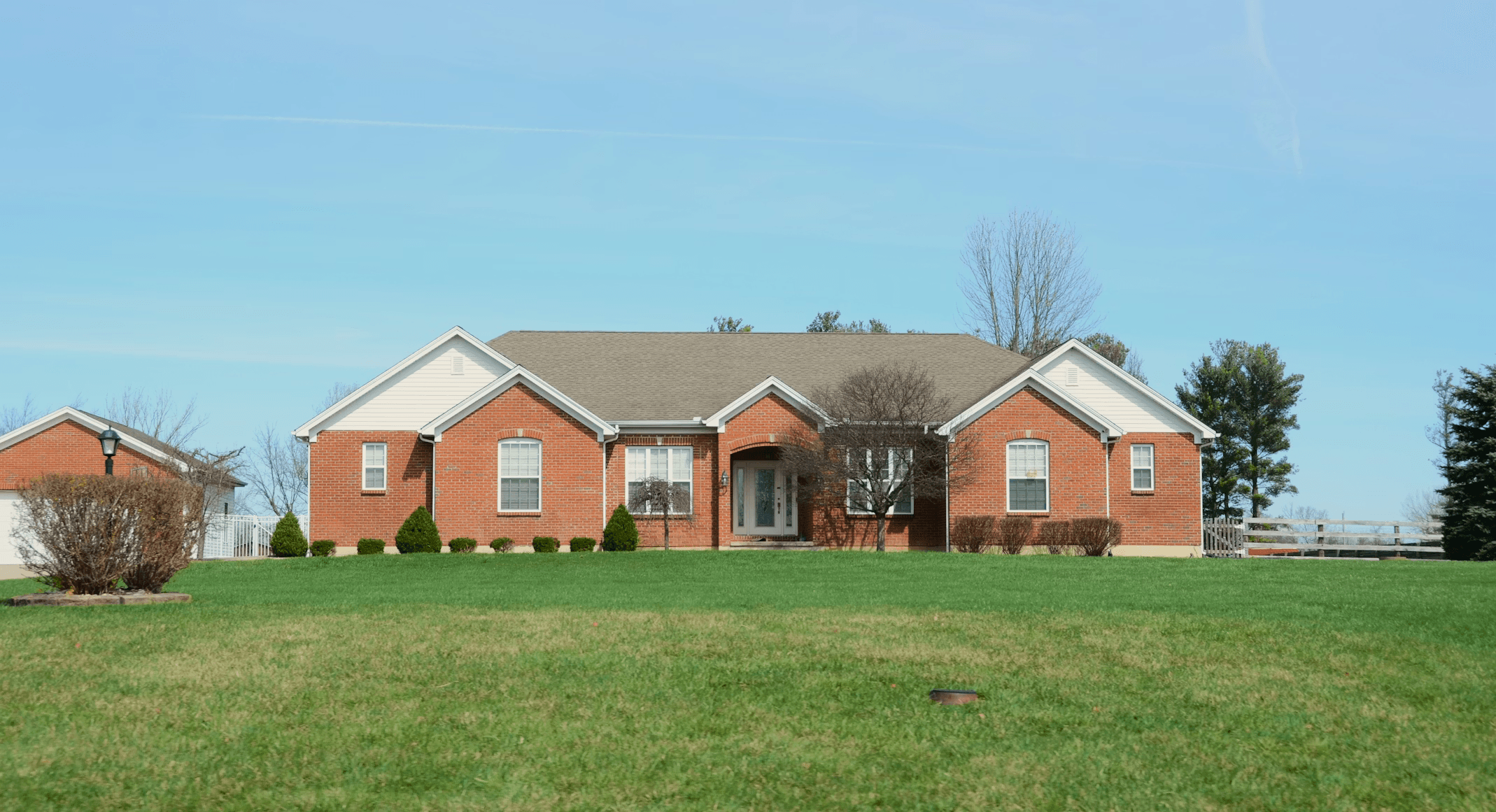 Images of houses exteriors in a neighborhood with well-maintained lawns and trees