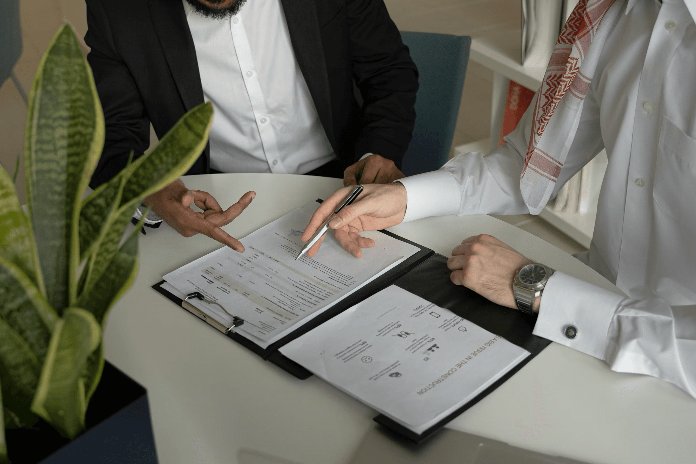 Office workers filling insurance paperwork in a modern office