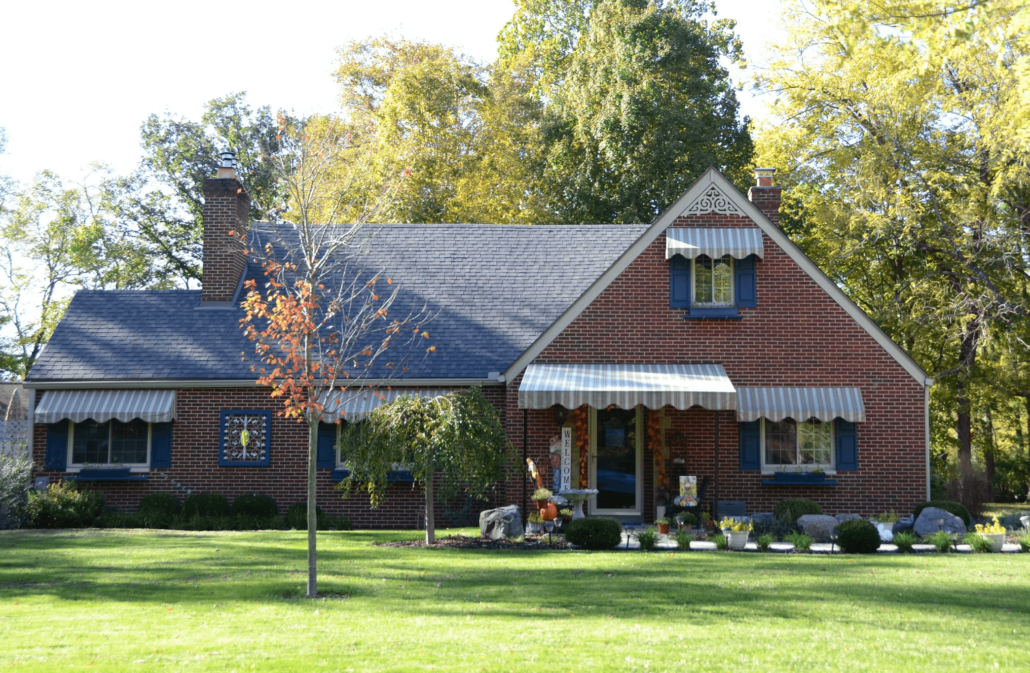 Images of houses exteriors in a neighborhood with well-maintained lawns and trees