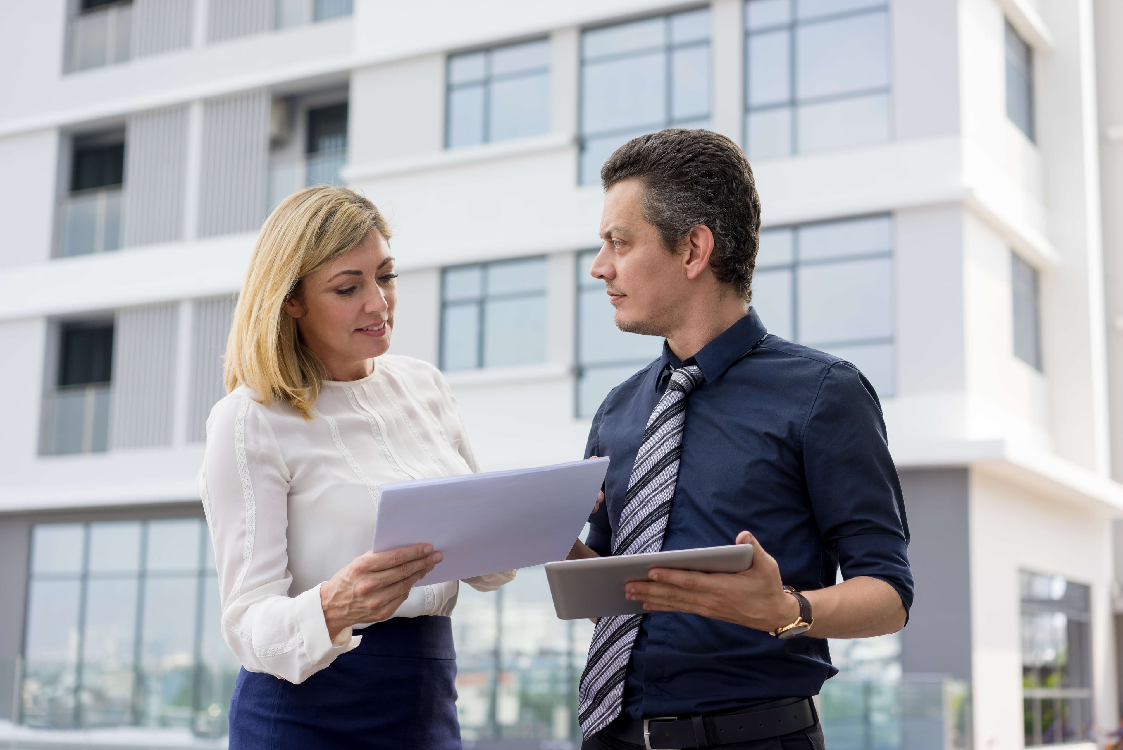 Two people dealing with commercial insurance paperwork